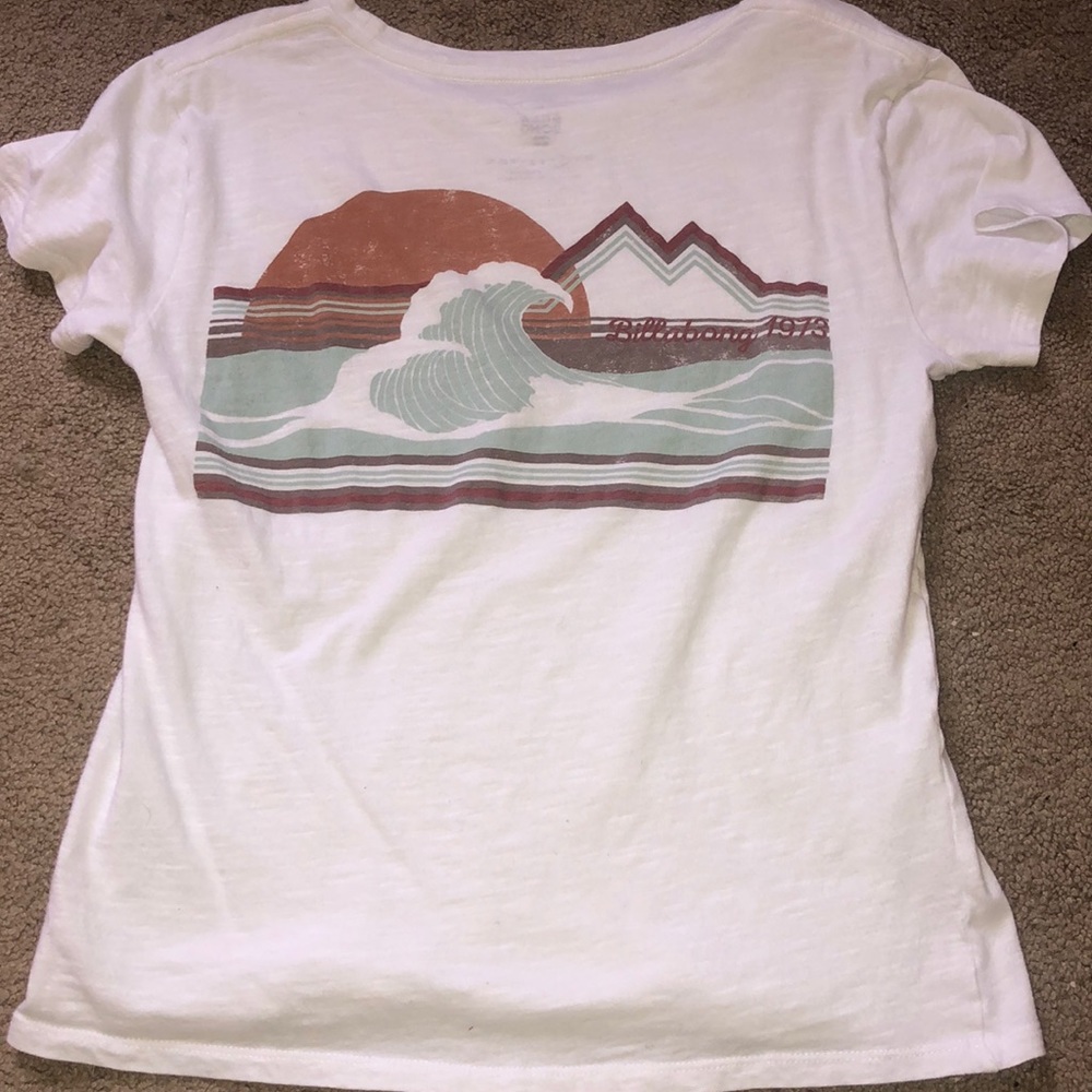 White billabong shirt with wave design on the back